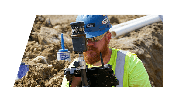 A Ken Neyer Plumbing worker surveying a construction site